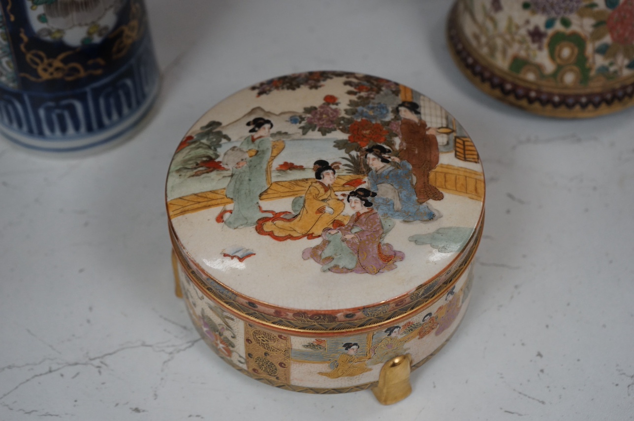 A Japanese Satsuma circular box and cover, a similar vase and an Imari sleeve vase, largest 30cm high. Condition - sleeve vase cracked, others good